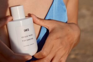 Amanda holding a fragrance bottle